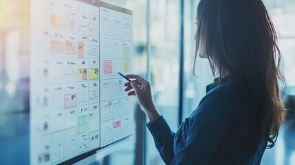 Business planning concept with a virtual screen calendar, a professional woman marking tasks and setting reminders for a balanced work schedule