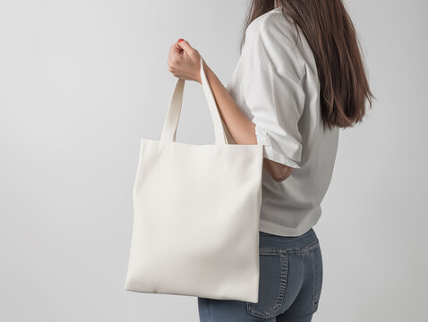 woman holding blank canvas fabric bag mockup