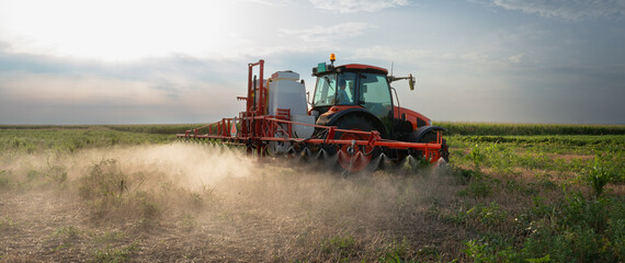 Fototapeta premium Tractor preparing the land for a new crop planting