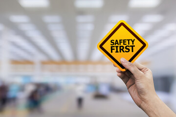 Hand holding safety first symbols for work safety, Safety first concept.