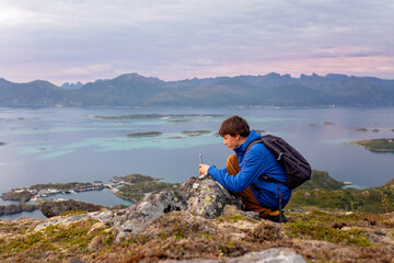 Fototapeta premium Family with children and pet, hiking Sukkertoppen trail on Senja island, Norway