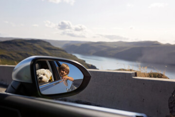 Family with children and pet dog, visiting Nordkapp during the summer holiday