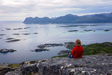 Fototapeta premium Family with children and pet, hiking Sukkertoppen trail on Senja island, Norway