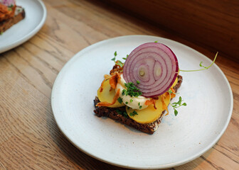 smorrebrod is a typical sandwich from Scandinavia and Denmark filled with many vegetables herbs