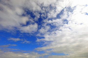 deep blue sky with clouds ideal as a backdrop for nature or weather forecast