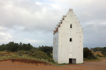 Fototapeta premium Today only the bell tower remains in Northern Denmark of the Sand-Covered Church called Den Tilsandede Kirke in Danish language