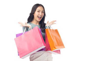 Cheerful young woman holding colorful shopping bags in both hands, expressing joy and excitement. Set against a clean white background, her enthusiasm captures the fun of a successful shopping spree