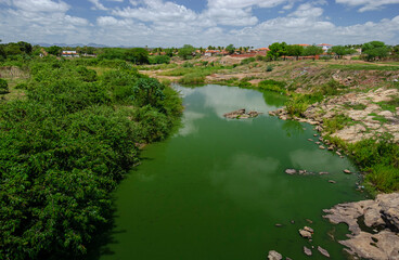 River in the interior of northeastern Brazil with plenty of water, polluted, during the rainy...