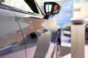 Close up on shiny gray coat of car with flush door handles popping out from vehicles surface. New...