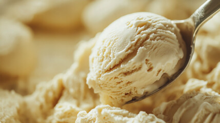 Fototapeta premium A close-up of a spoon dipping into a scoop of creamy, rich ice cream