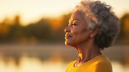 Tranquil Lakeside Yoga: Serene Silhouette of Elderly Black Woman Finding Peace and Mindfulness through Nature and Aging