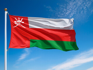 Oman flag waving in the wind against a blue sky background