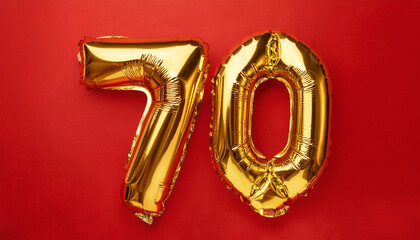 Balloon in shape of number 70 against vivid red backdrop. Happy Birthday. Holiday celebration