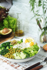 A bowl with a salad made of green vegetables