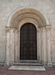 Ornate door on an ancient church with historical architecture