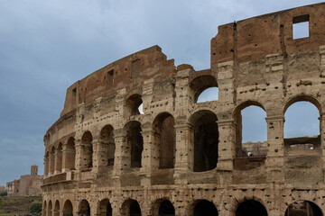 Obraz premium Roman Colosseum, the largest ancient amphitheatre ever built, Italy. Arches, exterior facade. Rome, Italy