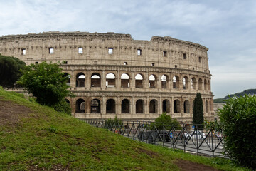 Obraz premium Roman Colosseum, the largest ancient amphitheatre ever built, Italy. Arches, exterior facade. Giardinetto del Monte Oppio. Rome, Italy