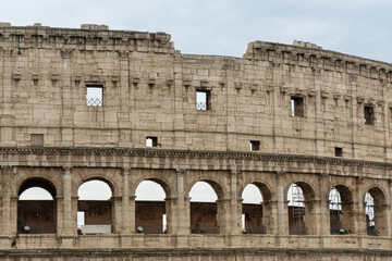 Roman Colosseum, the largest ancient amphitheatre ever built, Italy. Arches, exterior facade....
