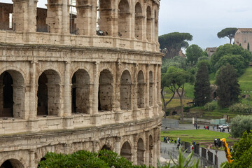 Roman Colosseum, the largest ancient amphitheatre ever built, Italy. Arches, exterior facade....