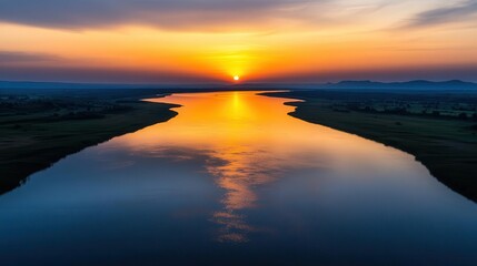 Hazy sunset over a calm river, humid weather, golden hour light
