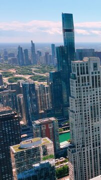 Downtown Chicago view of the Millennium Park and New Eastside district. Sunny summer day. Vertical video.