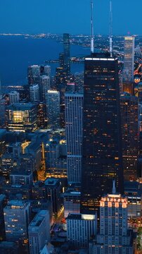 Chicago skyline by night. View of skyscrapers and streets with lights on the background of Lake Michigan. Vertical video.