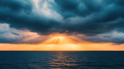 Sun rays breaking through dark storm clouds over the ocean, dramatic weather, hope after the storm