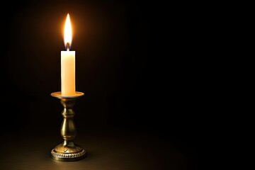 Serene candlelight on dark backdrop with vintage brass holder