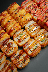Set of fried rolls on a black background