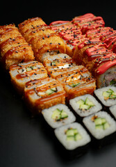 Set of fried rolls on a black background