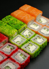 Set of sushi rolls on a black background