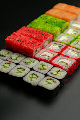Set of sushi rolls on a black background