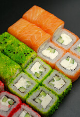 Set of sushi rolls on a black background