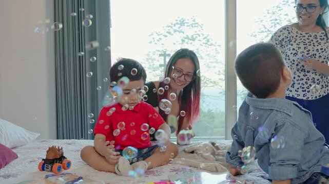 video of family playing in the room with bubbles