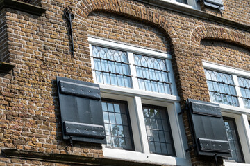 Window with shutters on a medieval building in the netherlands