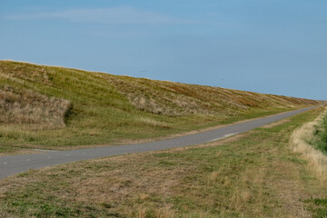 long cycle path along the dike on the dutch north sea