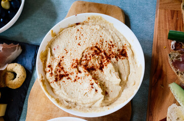 humus with pepper on a wooden plate