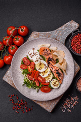 Delicious fresh caesar salad with salmon, lettuce, tomatoes and egg