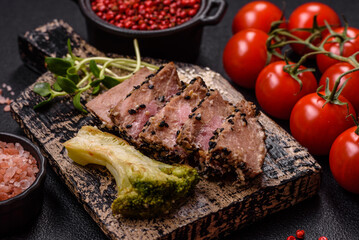 Bowl with slices of baked tuna with broccoli, tomatoes and fusili pasta