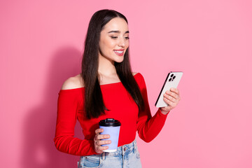 Portrait of pretty young girl smart phone coffee red top isolated on pink color background