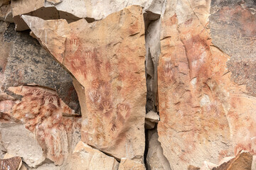 Ancient rock art at Cueva de Las Manos ( Cave of the Hands ) in Santa Cruz Province, Patagonia, Argentina. The art in the cave dates from 9,0001 to 13,000 years ago.