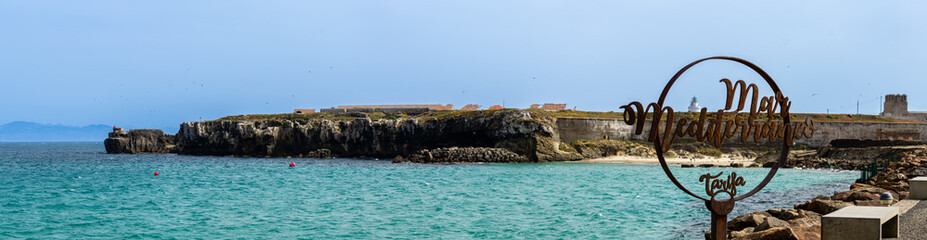 Fototapeta premium The famous symbol on the pathway that divides the Atlantic Ocean from the Mediterranean Sea in Tarifa, Spain