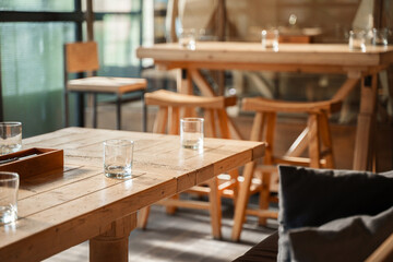 The aesthetic COZY appearance of an empty cafe with wooden furniture and minimalism.