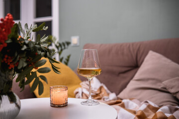 A Cozy Living Room Featuring Wine and Softly Flickering Candles for a Perfect Ambiance