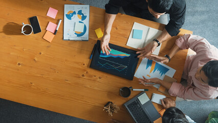 Executive manager explain financial graph to colleague at meeting room. Top aerial view of diverse...