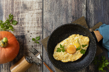 Khachapuri, baked cottage cheese pumpkin bread with cheese and egg filling on rustic wooden table. Georgian cuisine meal.