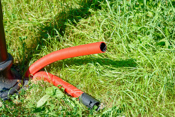 Naklejka premium Red plastic pipes for wiring electrical wires underground.