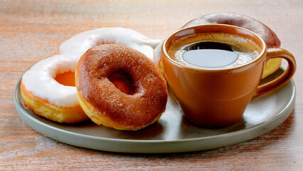 Cup of Coffee and Donuts on a Ceramic Plate on a Wooden Table