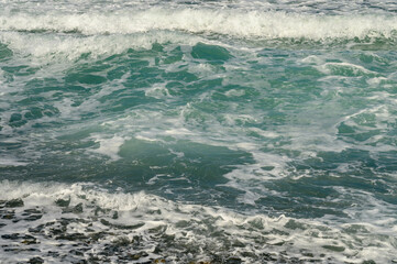 mediterranean sea waves crushing on a pebble beach