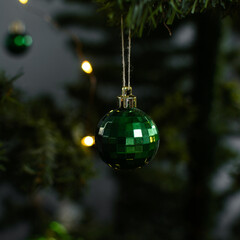 green Christmas decorations on a christmas tree, sparkly green christmas tree baubles on artificial...